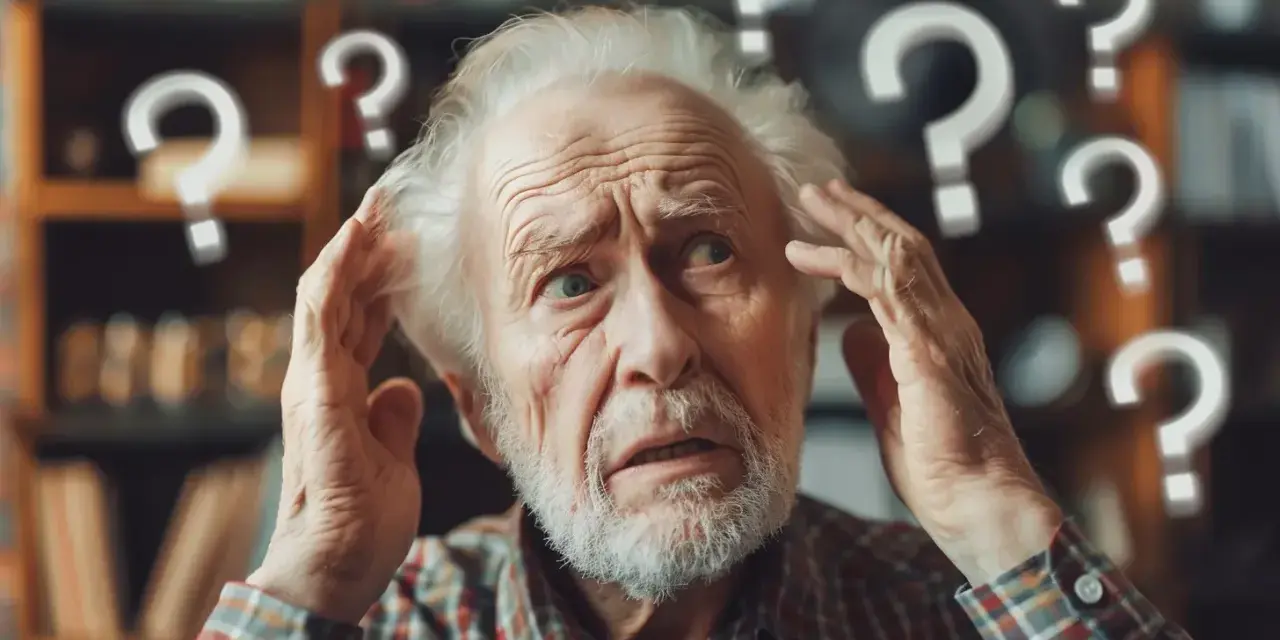 Starszy mężczyzna zdezorientowany, trzymający się za głowę. Wokół niego unoszą się znaki zapytania, symbolizujące chorobę Alzheimera i utratę pamięci.